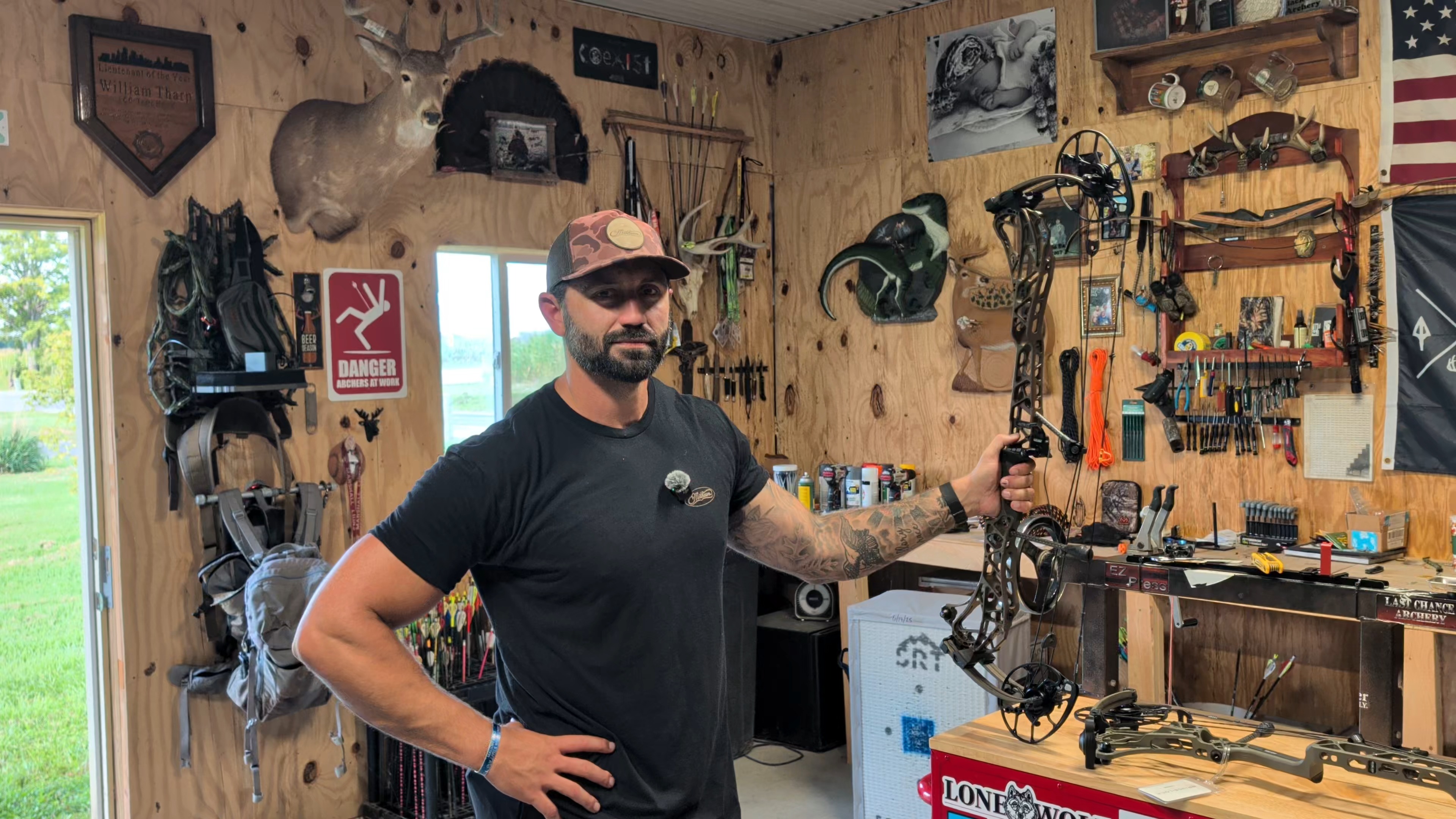 Tharp standing at the entrance to Black Flag Archery