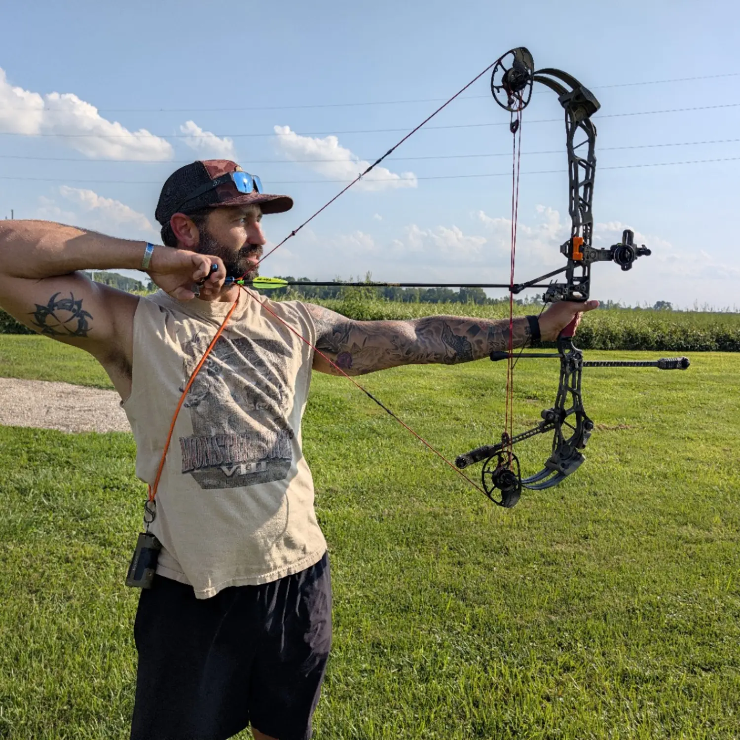Tharp shooting a compound bow at full draw
