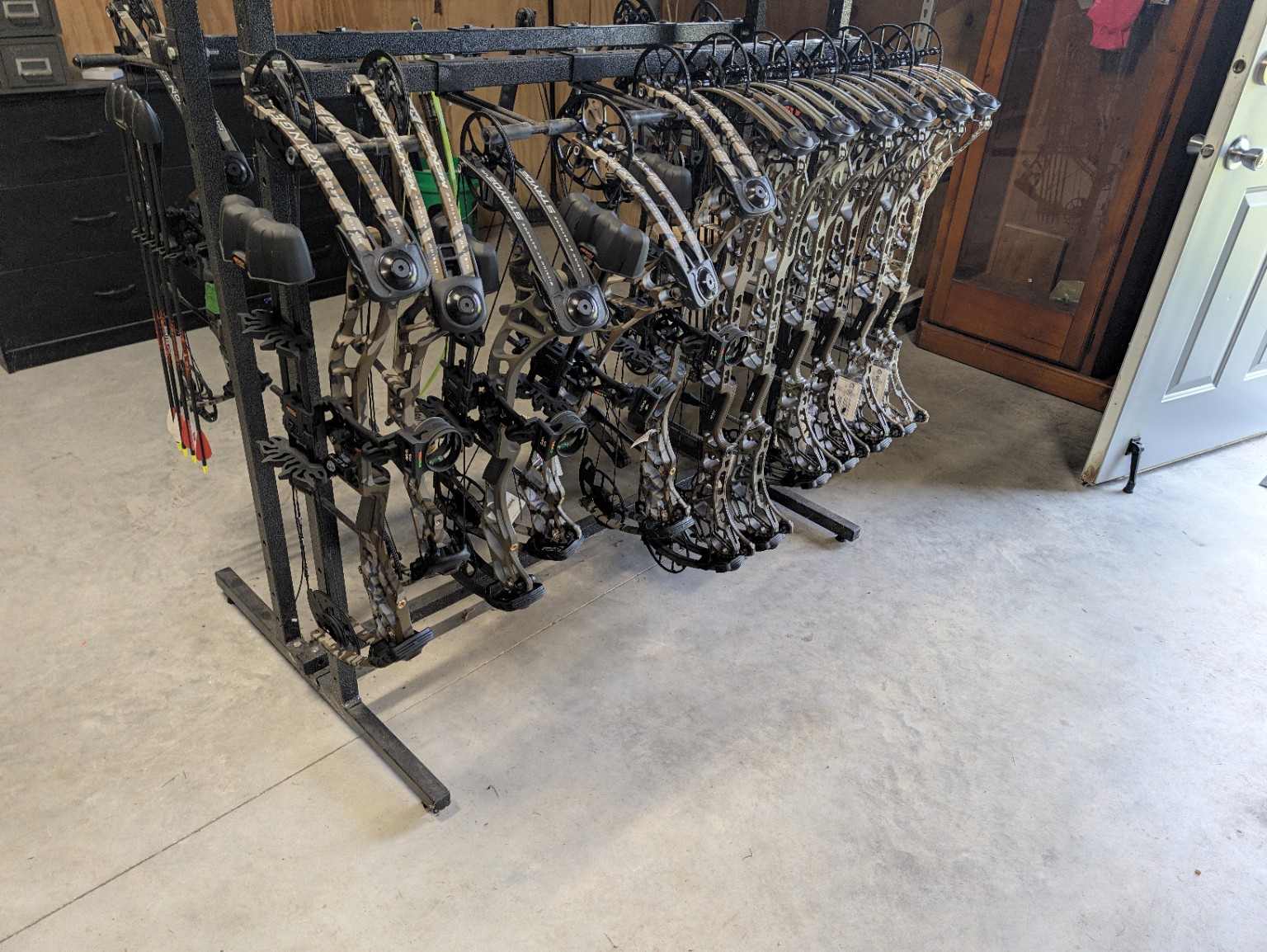 Rows of compound bows available in the Black Flag Archery showroom