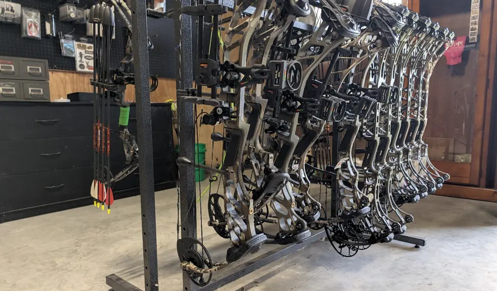 Rows of compound bows displayed on the Black Flag Archery showroom rack
