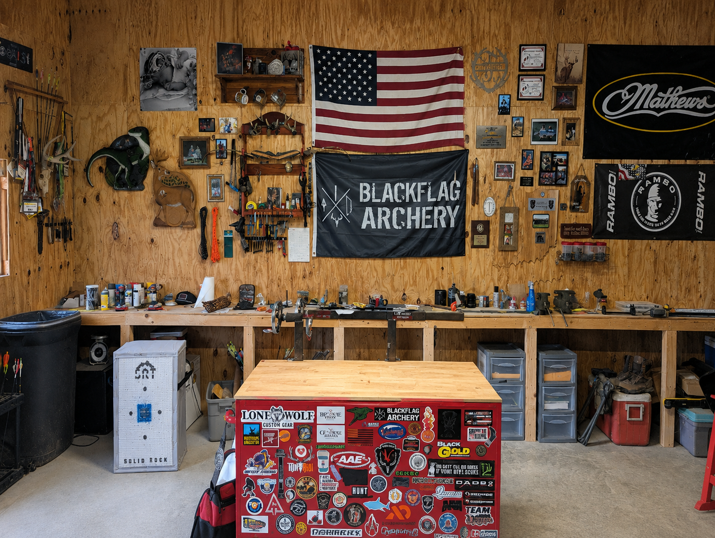 A stocked rack of compound bows inside Black Flag Archery